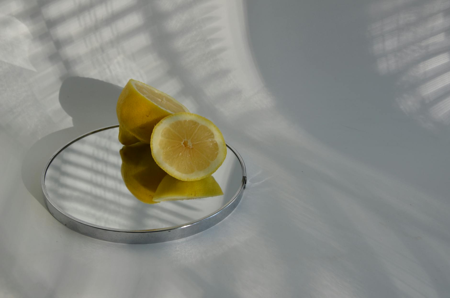 A colorful lemon clitoral vibrator surrounded by flowers and citrus slices on a vibrant yellow background