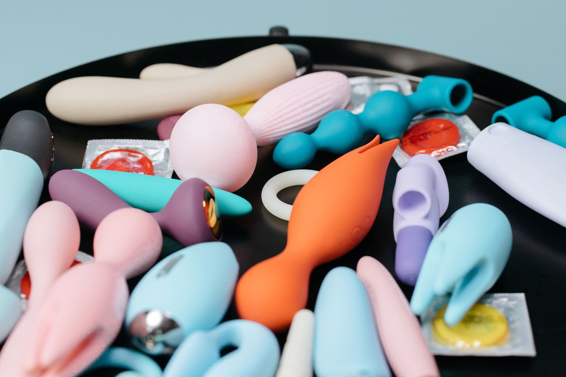 A collection of colorful personal massagers and toys arranged on display